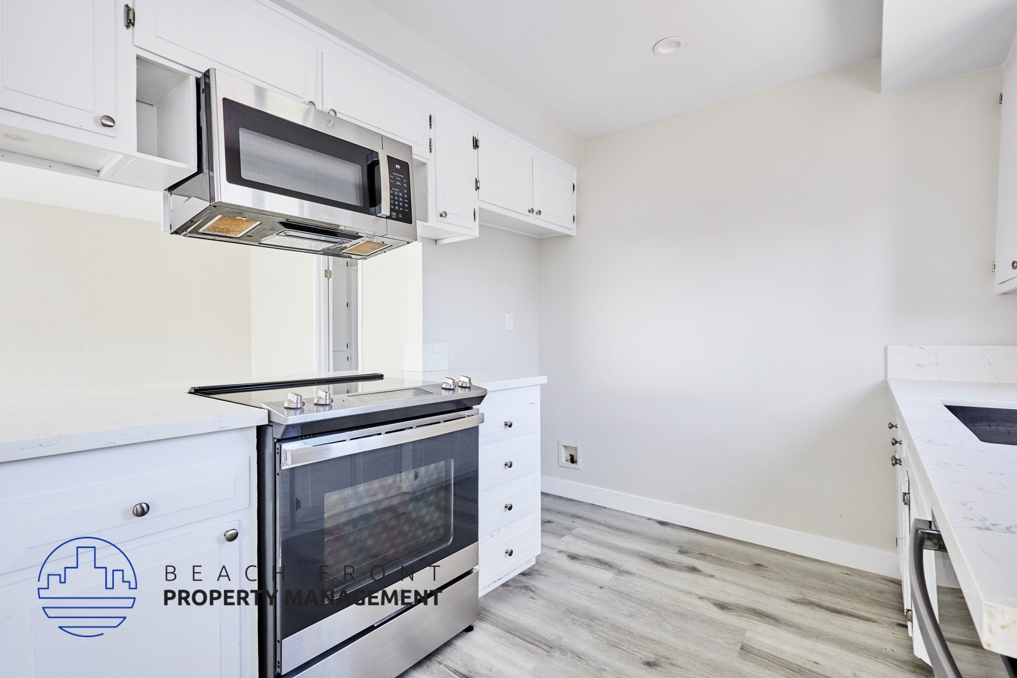 A kitchen with a stainless steel oven and microwave above it.